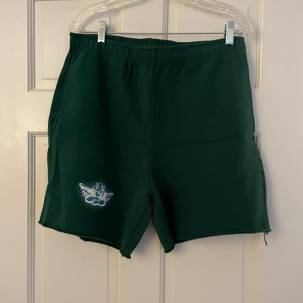 Green boy lies sweat-shorts